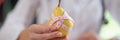 Nutritionist showing ripe yellow pear with measuring tape while sitting in medical office. Royalty Free Stock Photo