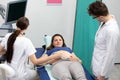 A nurse performs an ultrasound on a pregnant patient under the guidance of the attending doctor. Royalty Free Stock Photo