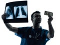 Doctor surgeon man examing dollar bill silhouette Royalty Free Stock Photo