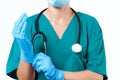 Doctor surgeon in sterile mask is wearing gloves before surgery Royalty Free Stock Photo