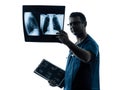 Doctor surgeon radiologist examining lung torso x-ray image sil