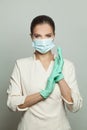 Doctor surgeon woman in protective medical mask and surgical gloves on white background Royalty Free Stock Photo