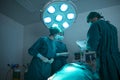 Doctor surgical are discussing. The surgeon team is working in the operating room. The surgeon is saving the patient`s life