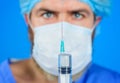 Doctor with syringe is preparing for injection. Vaccination for people. Coronavirus. Selective focus. Close up. Royalty Free Stock Photo