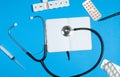 Doctor table with medical items, stethoscope and pills Royalty Free Stock Photo