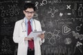 Doctor with tablet in front of blackboard Royalty Free Stock Photo