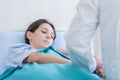 A doctor takes care of a sick patient woman with sadness and unhappiness at the hospital or medical clinic