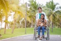 Doctor takes a patient on wheelchair