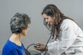 Doctor takes senior woman& x27;s arterial blood pressure. Health care