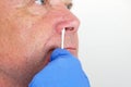 The doctor takes a test for coronavirus from the man`s nose close up Royalty Free Stock Photo