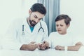 Doctor Taking Blood Sample from Boy`s Finger. Royalty Free Stock Photo