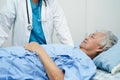 Doctor taking care, help and encourage Asian elder senior woman patient in clinic hospital Royalty Free Stock Photo