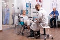 Doctor taking notes on clipboard discussing with invalid woman Royalty Free Stock Photo