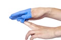 Doctor taking off her blue medical gloves. White background Royalty Free Stock Photo