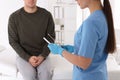 Doctor taking sample for STD testing from man in clinic, closeup Royalty Free Stock Photo