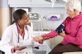 Doctor Taking Senior Female Patient's Blood Pressure Royalty Free Stock Photo