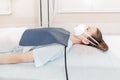 Doctor taking x-ray of patient lying on gurney. Hospital radiology room. Technician adjusting an x-ray machine. Female Royalty Free Stock Photo