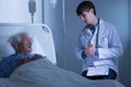 Doctor talking with ill man Royalty Free Stock Photo