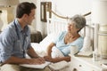 Doctor Talking With Senior Female Patient In Bed At Home Royalty Free Stock Photo