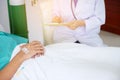 Doctor talking to male patient in hospital bed. doctor with clip Royalty Free Stock Photo