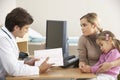 Doctor talking to mother and child Royalty Free Stock Photo