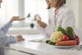 Doctor talking to patient about diet, eating healthy food and disease prevention Royalty Free Stock Photo