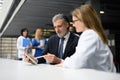 Doctor talking to pharmaceutical sales representative, shaking hands. Hospital manager talking with female doctor. Royalty Free Stock Photo