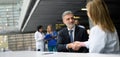 Doctor talking to pharmaceutical sales representative, shaking hands. Hospital manager talking with female doctor Royalty Free Stock Photo