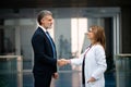 Doctor talking to pharmaceutical sales representative, shaking hands. Hospital manager talking with female doctor. Side Royalty Free Stock Photo