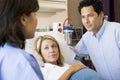 Doctor Talking To Pregnant Woman And Her Husband Royalty Free Stock Photo