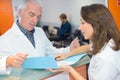 Doctor talking to secretary at reception