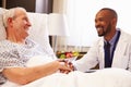 Doctor Talking To Senior Male Patient In Hospital Bed Royalty Free Stock Photo