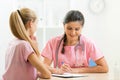 Doctor talking to teenager patient at office