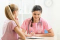 Doctor talking to teenager patient at office