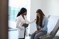 Doctor Talking To Unhappy Teenage Patient In Exam Room Royalty Free Stock Photo