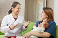 Doctor talks with mother of newborn baby Royalty Free Stock Photo