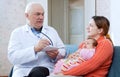 Doctor talks with mother of newborn baby Royalty Free Stock Photo