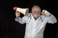 Doctor with tape across his mouth and listening to a message through a megaphone Royalty Free Stock Photo