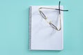 Doctor teacher glasses on blank spiral notebook