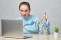 Doctor teacher tells an online lecture on the stomach showing on a mannequin