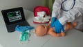 doctor teaching cardiac resuscitation on newborn with cardiac massage