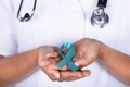 Doctor With Teal Ribbon Showing Ovarian Cancer Awareness