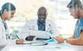 Doctor team conversation about medical document in a meeting together at work. Healthcare workers talking while planning Royalty Free Stock Photo