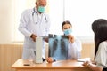 Doctor Team examining and checking at chest and lung x ray film of patient at hospital room Royalty Free Stock Photo
