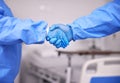 Doctor, team and handshake with gloves in partnership, meeting or introduction together at hospital. Closeup of medical Royalty Free Stock Photo