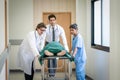 Doctor team and nurse staff carrying stretcher with patient from the accident ambulance running to the surgery room in hospital Royalty Free Stock Photo