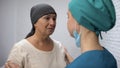 Doctor telling crying cancer patient about bad results of therapy, oncology