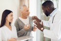 The doctor tells the nurse how an elderly male patient should take pills. Royalty Free Stock Photo