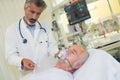 Doctor tending to patient wearing oxygen mask Royalty Free Stock Photo