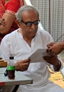Doctor test sight of Indian man reading chart,in a medical camp